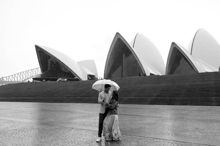 Black and white engagement photo at Sydney Opera House by Emma Hampton