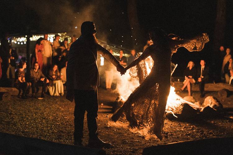 Bride and Groom dancing beside bonfire at Midginbil Eco Resort