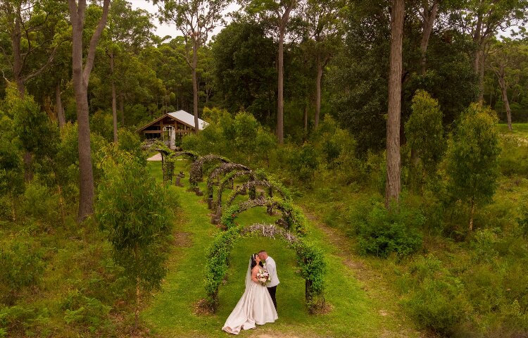 Bush chapel and arch aisle surrounded by trees at The Woods Farm Jervis Bay