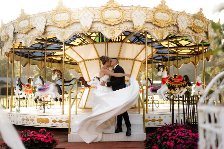 Bride and Groom kissing on fairground at Mackay Family Estate in Central Coast