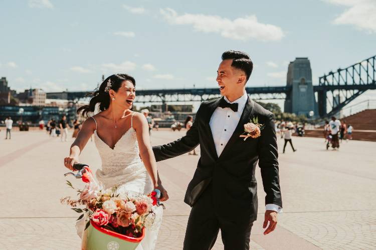Fun Bride on bike with Groom at Circular Quay shot by Kevin Lue Photography