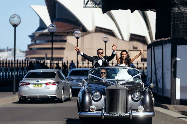 Wedding photo with Bride & Groom in bridal car near the Sydney Opera House