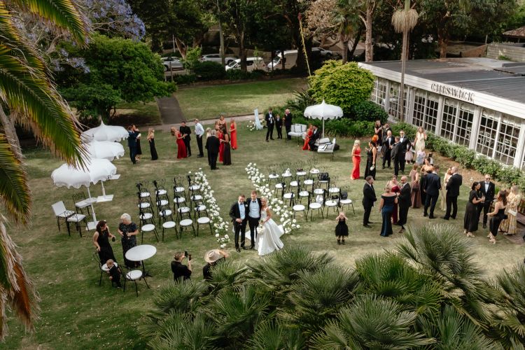 Tropical garden wedding ceremony in park-like grounds at Chiswick Woollahra