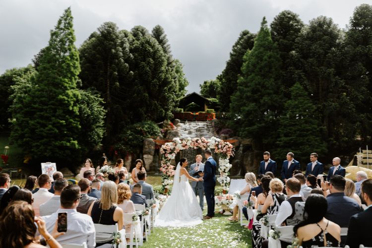 Hunter Valley Gardens wedding ceremony with waterfall in background