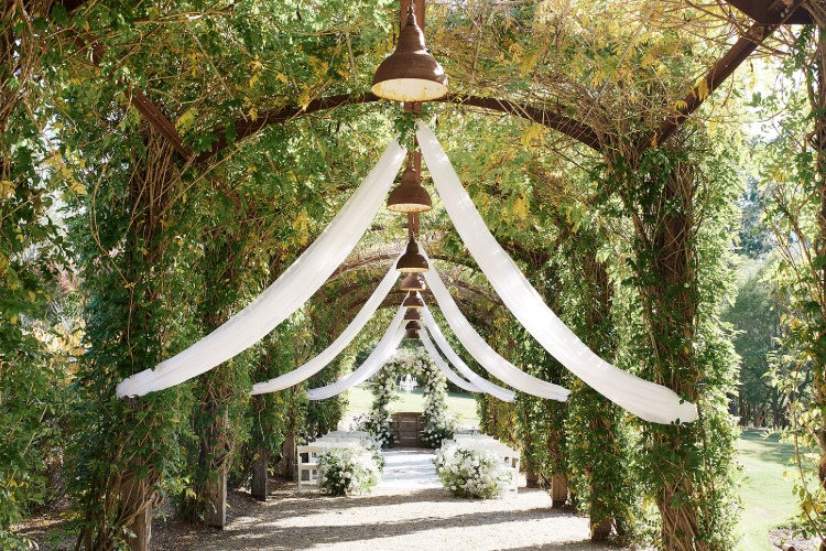 Garden wedding venue with green covered arbor at Fernbank Farm
