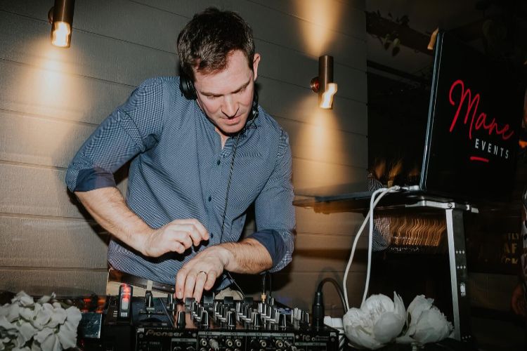 Newcastle disc jockey Mane Events mixing songs at a wedding reception
