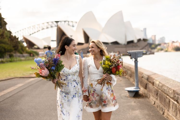 Candid wedding photo with two Brides at the Sydney Opera House by Carlita Sari