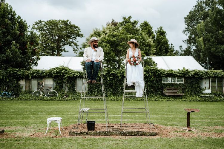 Nowra wedding venue with Bride & Groom on tennis chairs at Driftwood Shed