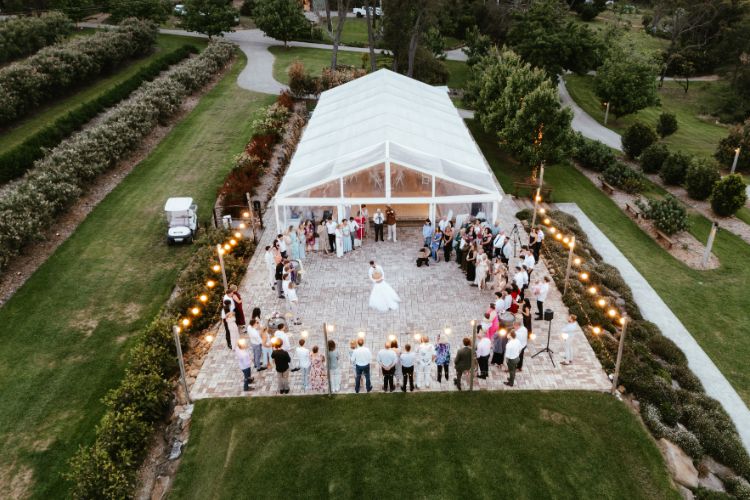 Open-air marquee wedding with outdoor dance floor at Growwild Wildflower Farm
