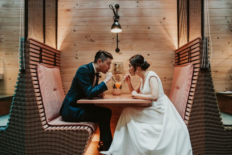 Reportage wedding photography with couple drinking a cocktail by Kevin Lue