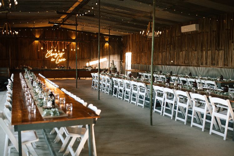 Rustic barn reception venue with long tables at Moravia Park