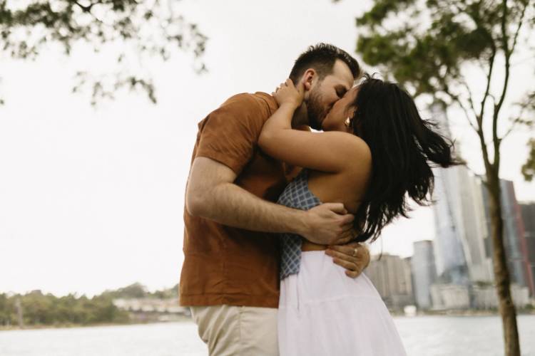 Engagement Photo with couple embracing on Sydney Harbour by Anna Murray