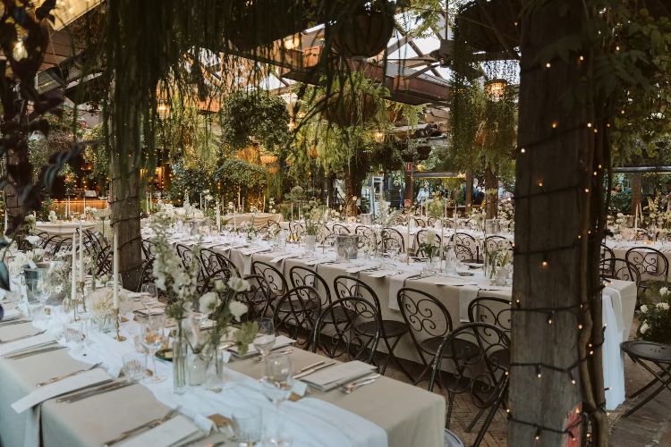 The Grounds Garden Room set for a wedding reception under hanging pots