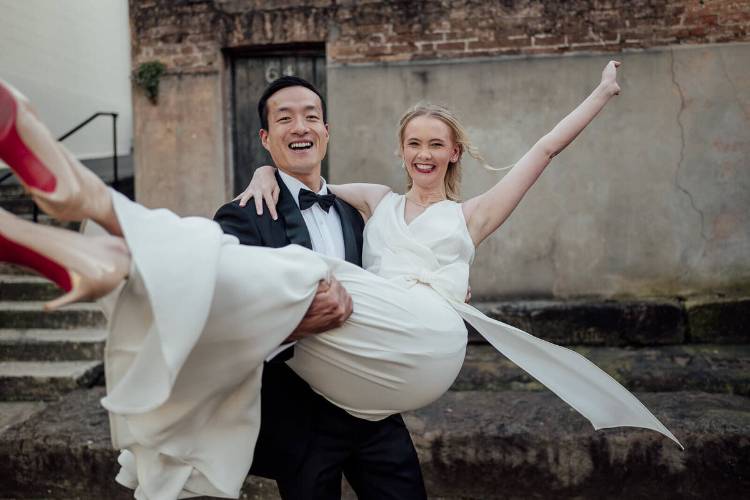 Groom carries Bride at iconic doorway in The Rocks - Images By Kevin