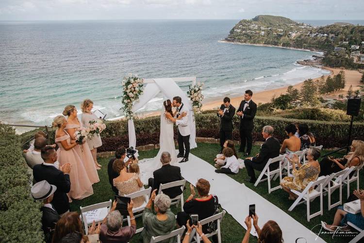 Scenic wedding ceremony at Jonah's Whale Beach by James Thomson Photography