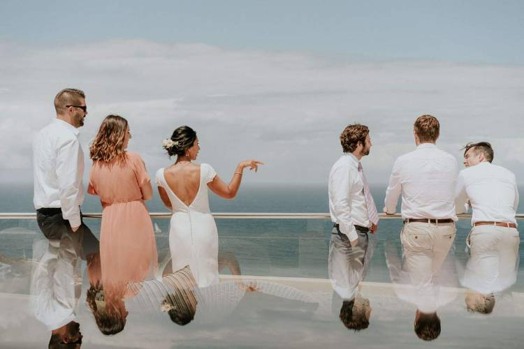 Wedding guests on an oceanfront balcony at Jonah's Restaurant & Boutique Hotel