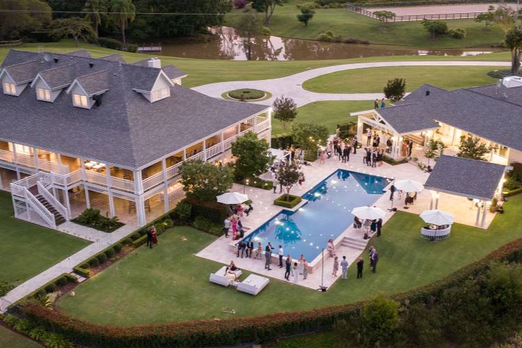 Private estate wedding venue in Queensland with guests by the pool